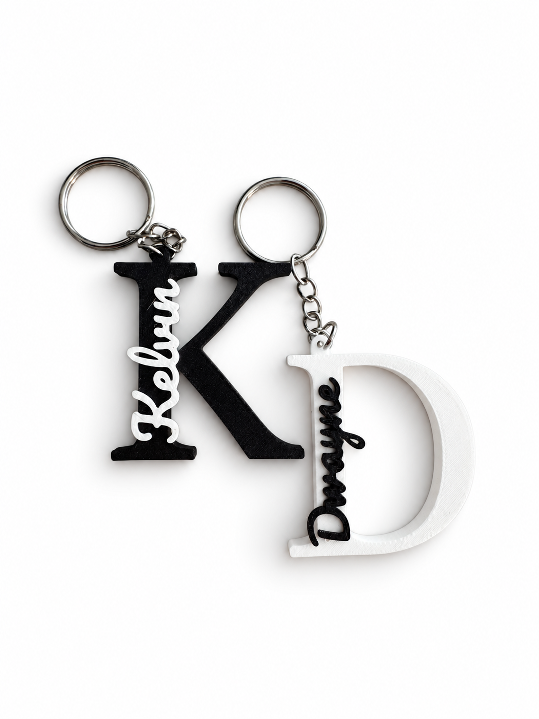 Original photo of personalised black K and white D initial and name keyrings